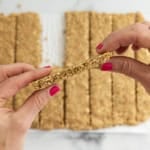 Hands holding healthy granola bar.