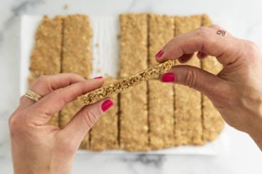 Hands holding healthy granola bar.