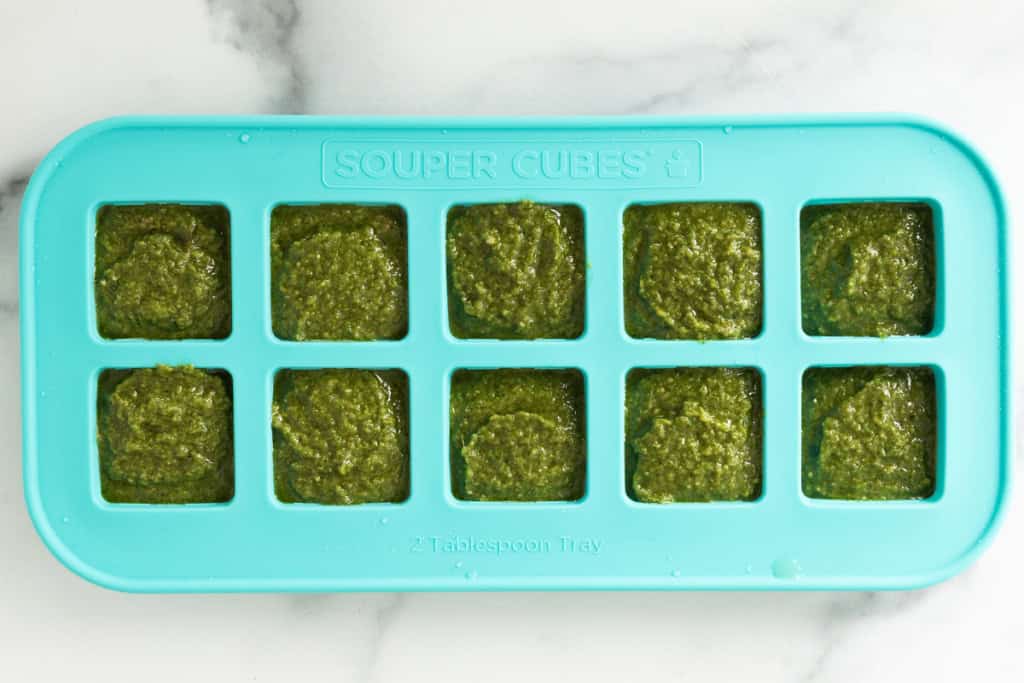 Nut free pesto in ice cube tray before freezing.