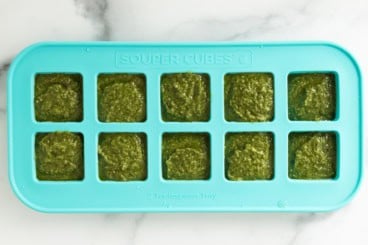 Nut free pesto in ice cube tray before freezing.