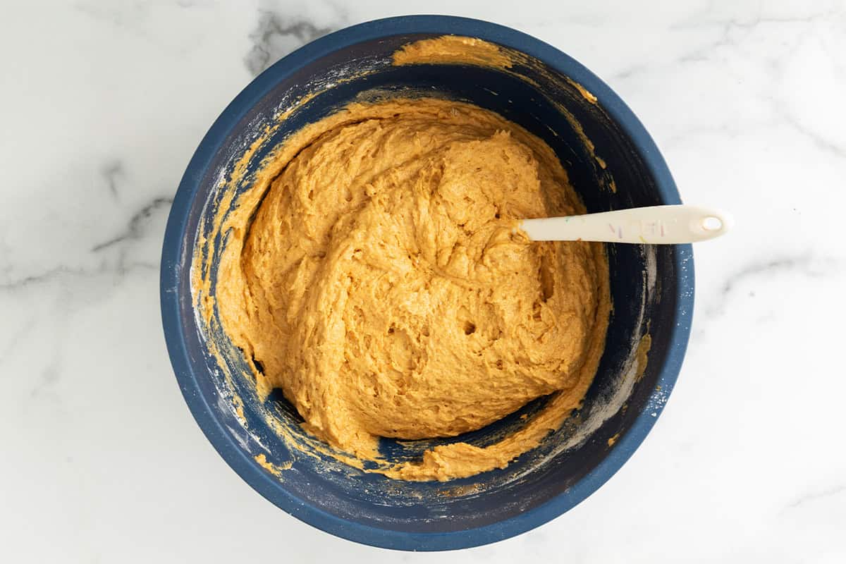 Batter for pumpkin bars in blue bowl.