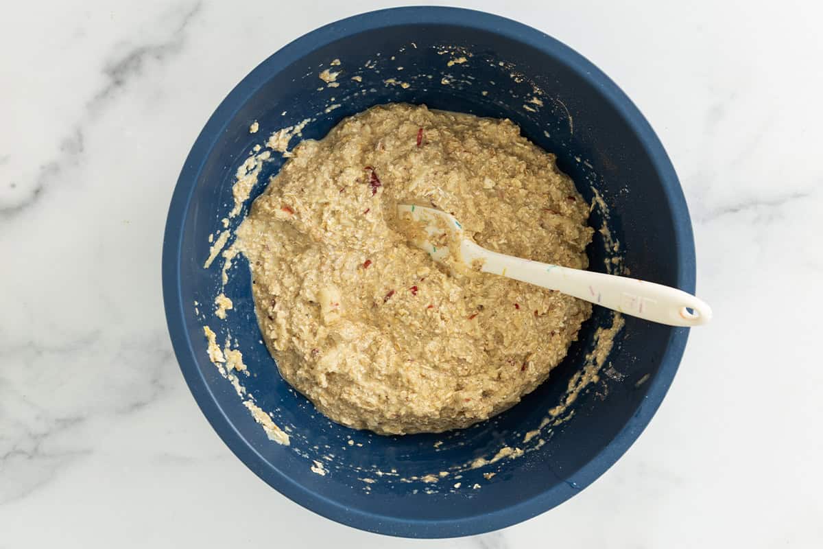 Apple oatmeal bars batter in blue bowl.