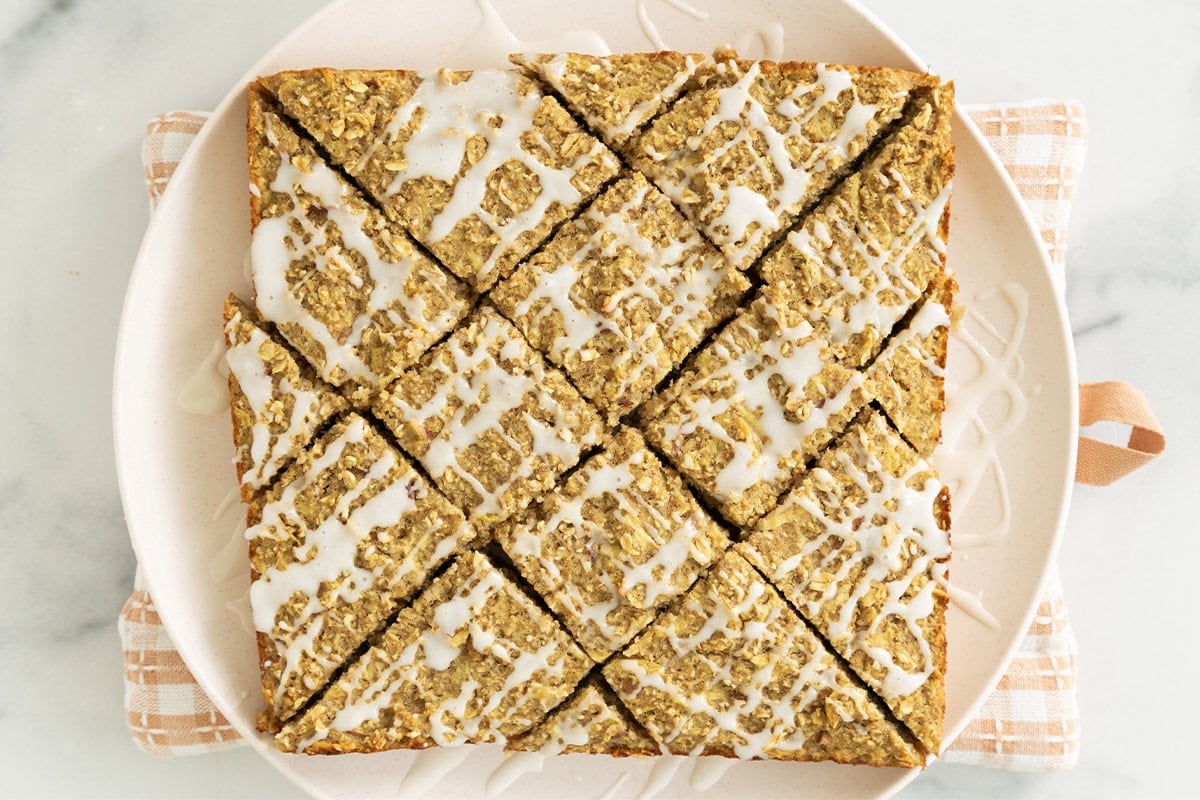 Apple oatmeal bars on white plate. 