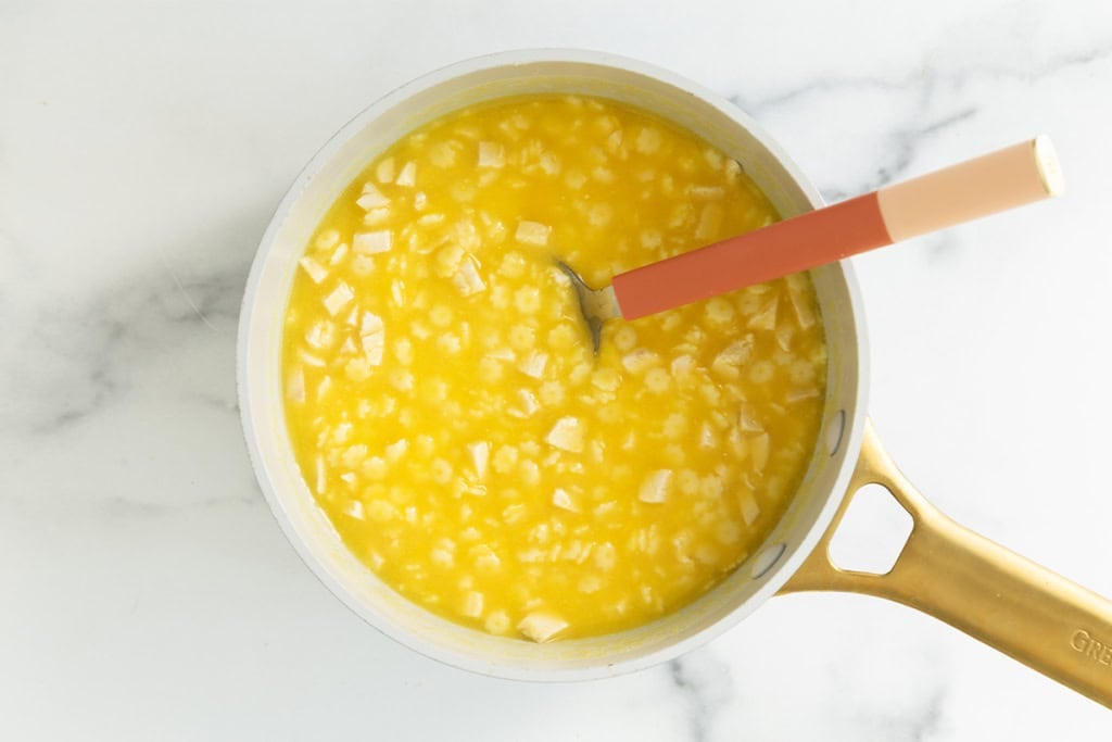 Baby soup in pot with spoon.