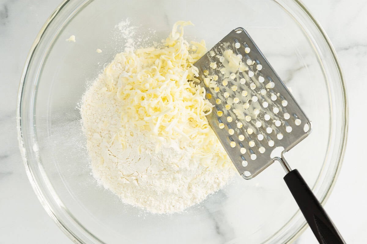 Butter and flour in glass bowl for biscuits.