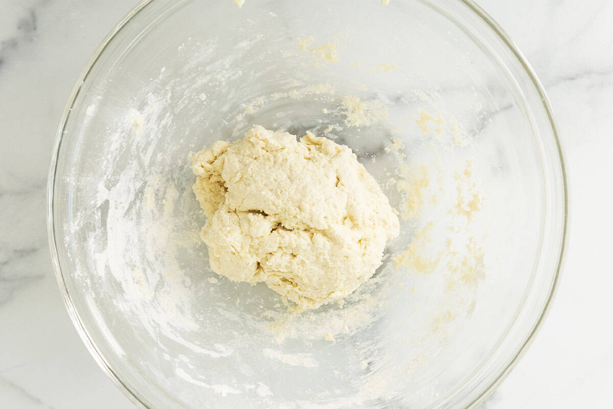 Dough for biscuits in glass bowl.