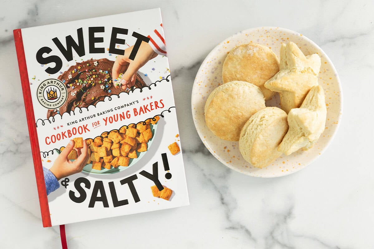 Plate of biscuits next to cookbook.