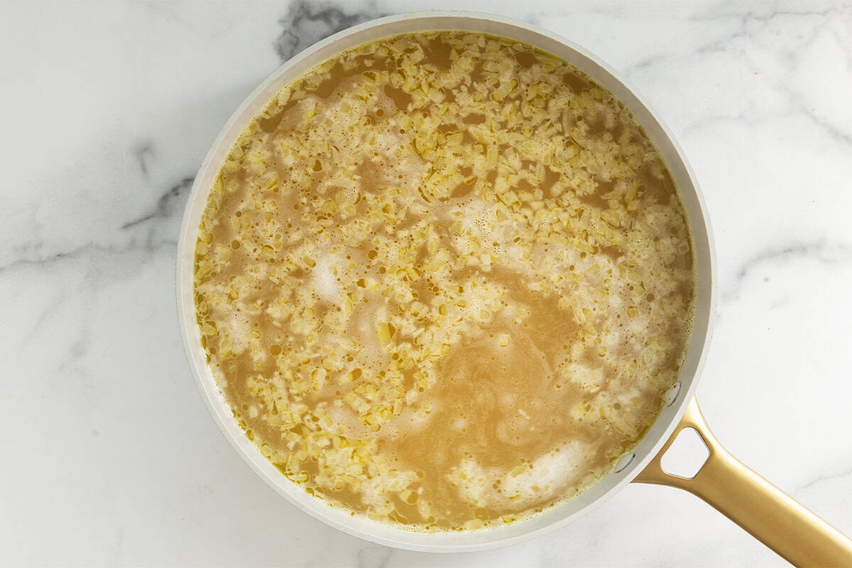 Noodles in broth for creamy pasta soup.