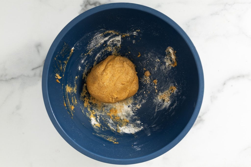 Pumpkin protein balls batter in blue bowl.