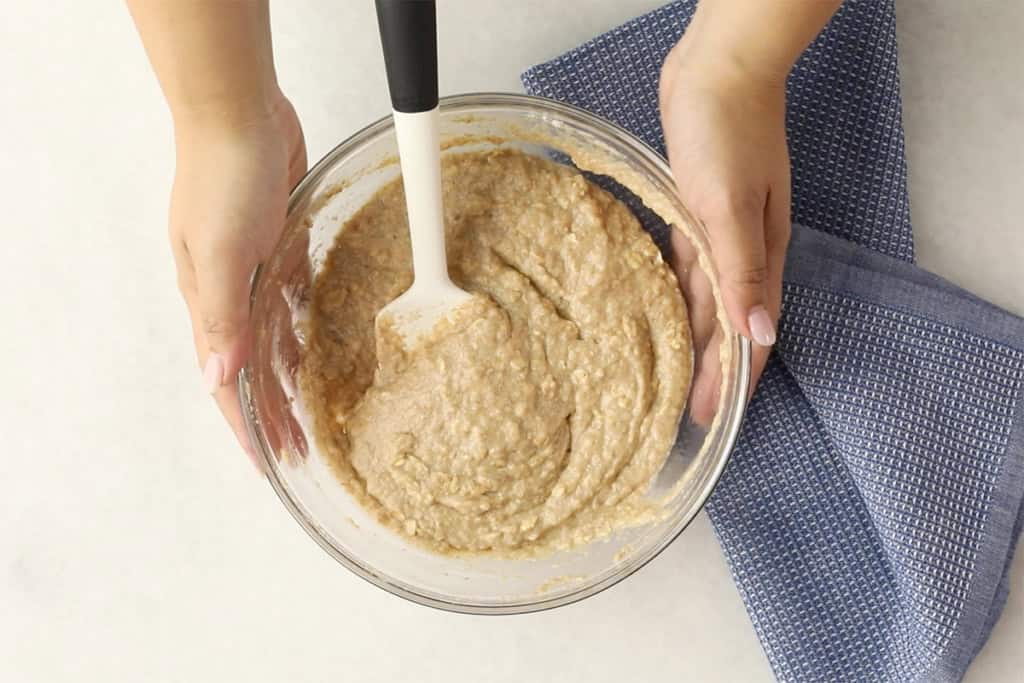 Batter for applesauce muffins in glass bowl.