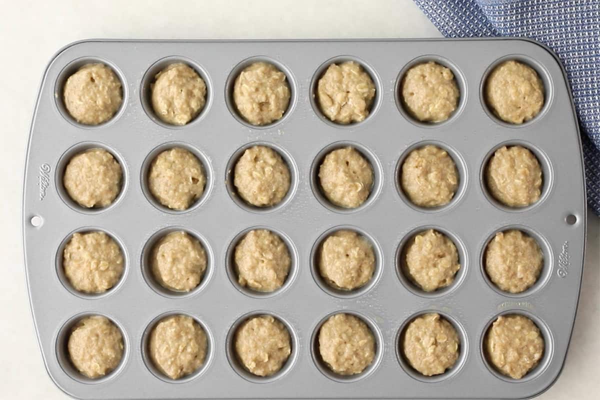 Batter for applesauce muffins in mini muffin pan.