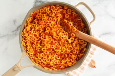 spaghettios in pan with wooden spoon.