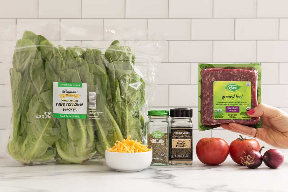 Ingredients for cheeseburger salad on countertop.