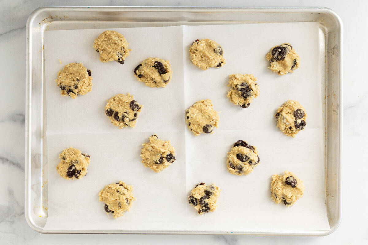 Cherry chocolate chip cookies on sheet pan before baking.