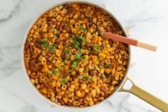 Veggie chili mac in pan with spoon.