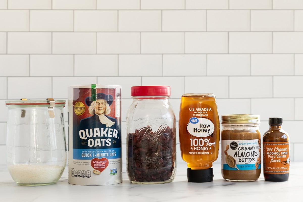 Ingredients for almond butter protein balls on countertop.