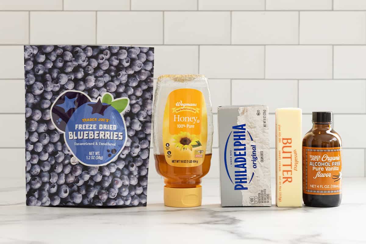 Ingredients for blueberry cream cheese frosting on countertop.