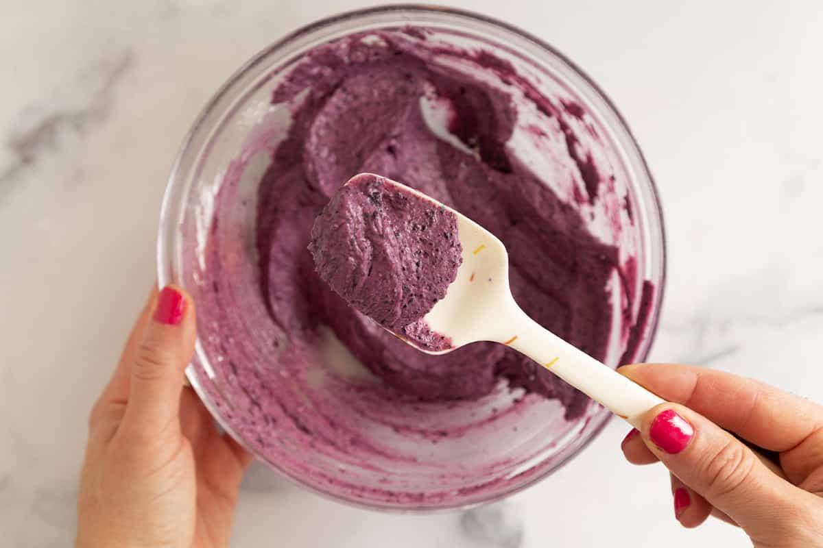 Blueberry cream cheese frosting in glass bowl.