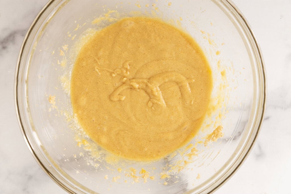 Wet ingredients for cranberry cookies in glass bowl.