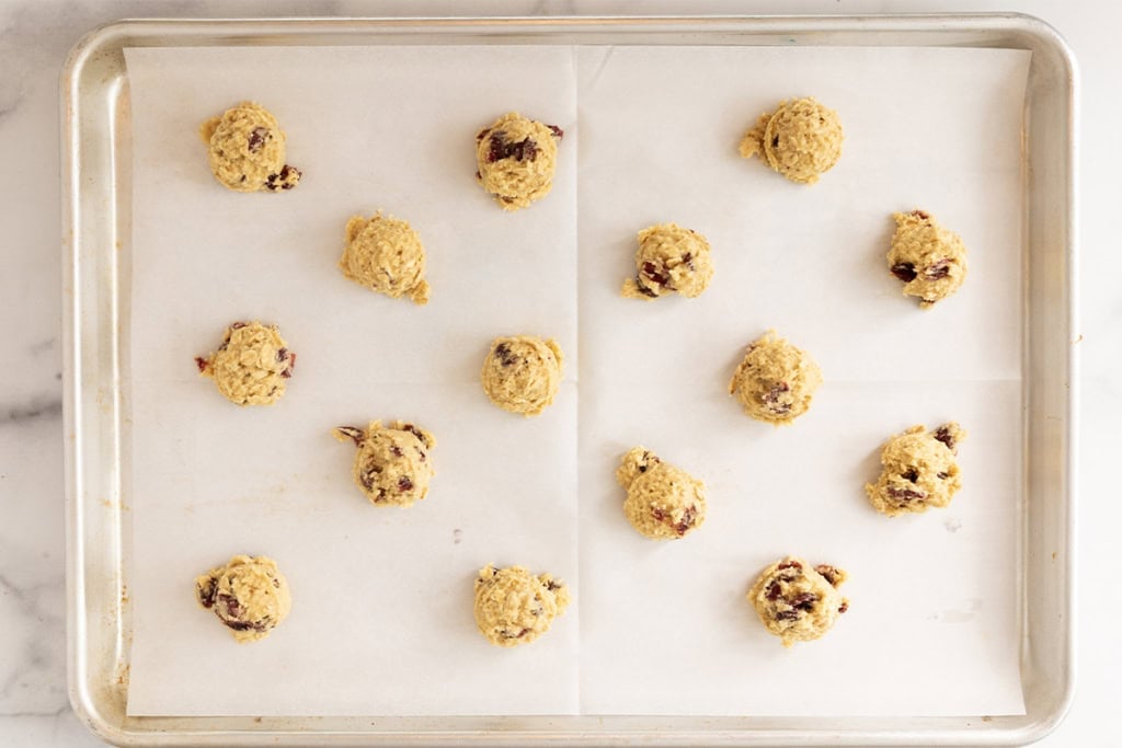 Cranberry cookies on baking sheet before baking.