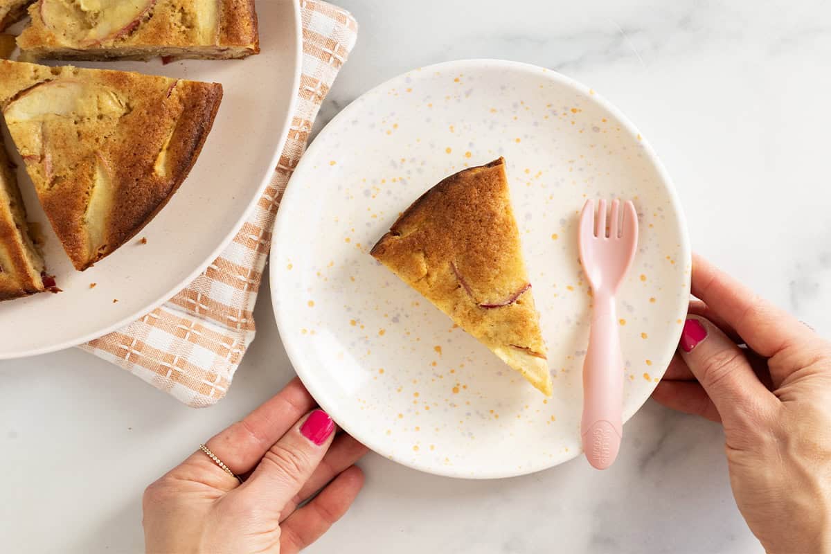 slice of apple cake on plate with pink fork.