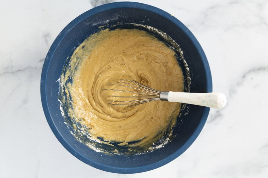 mixed batter for apple cake in bowl.