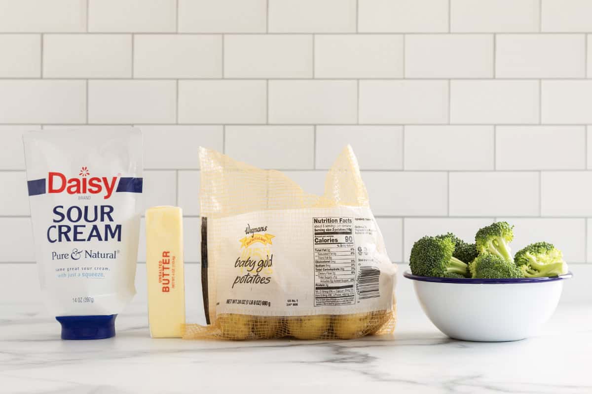 Ingredients for mashed potatoes with broccoli on countertop.