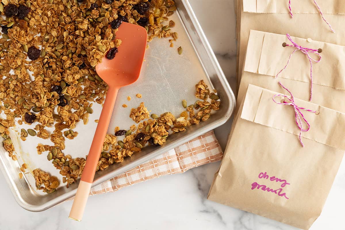 Packing olive oil granola into brown storage bags.