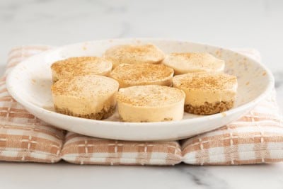 Pumpkin cheesecake bites on plate.