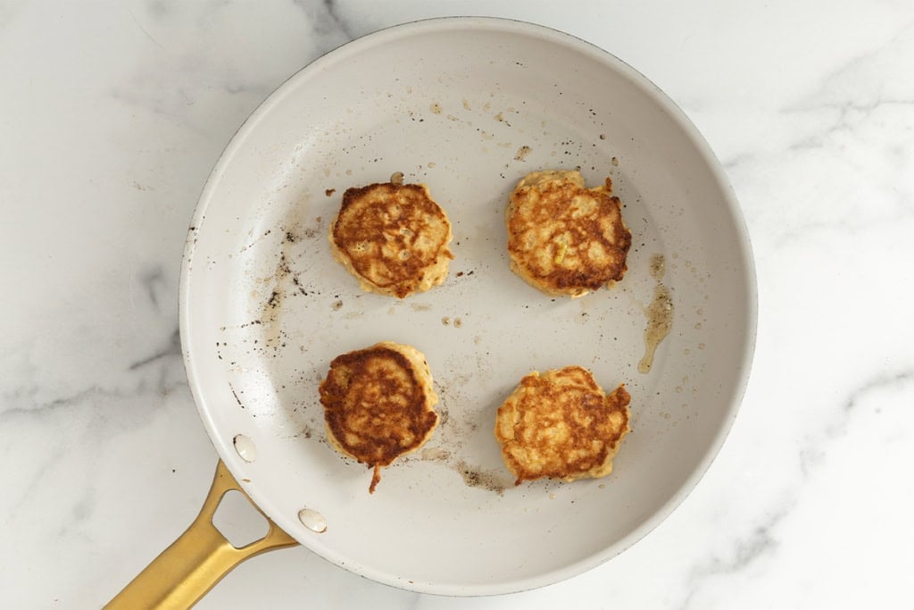 Apple oatmeal pancakes in pan.