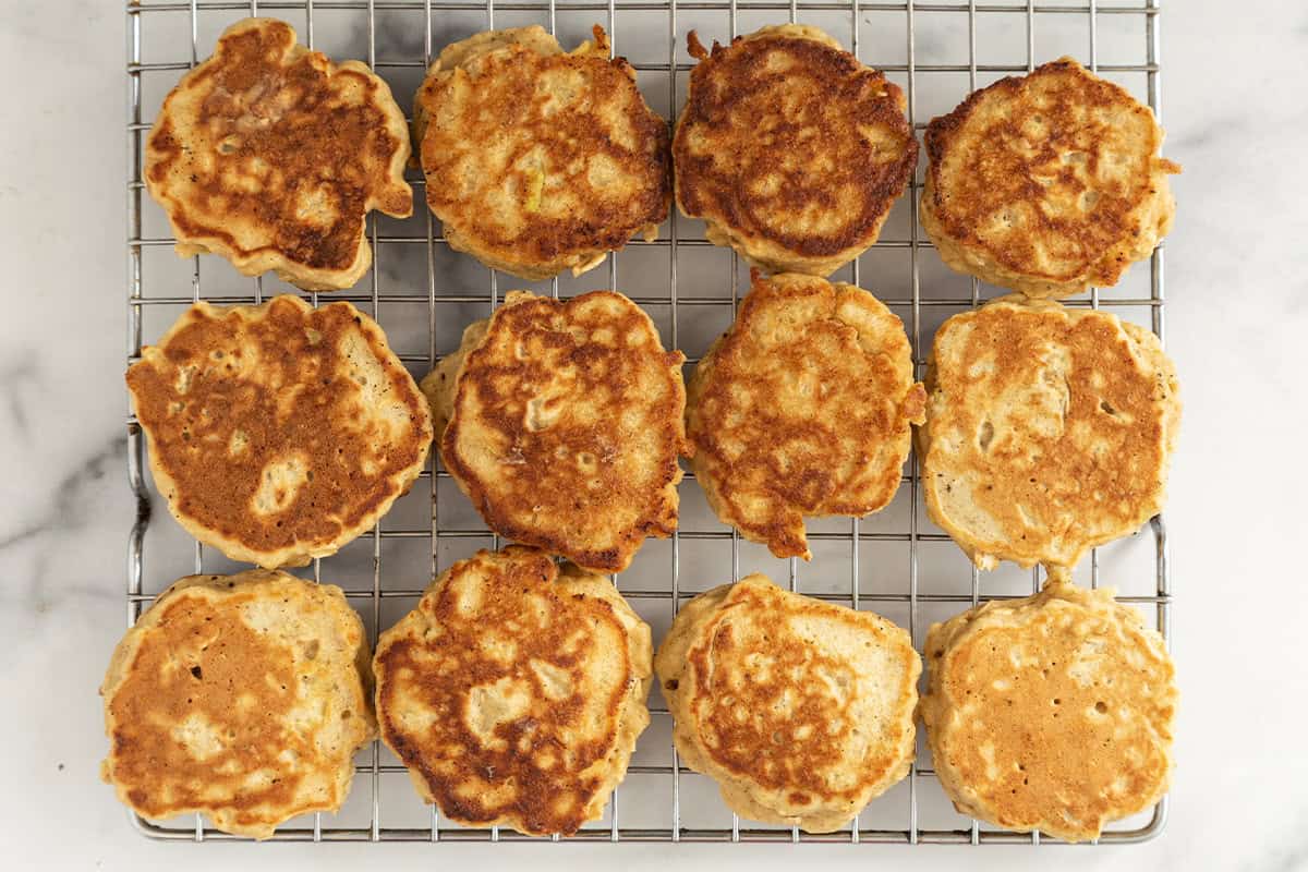 Apple oatmeal pancakes on cooling rack.