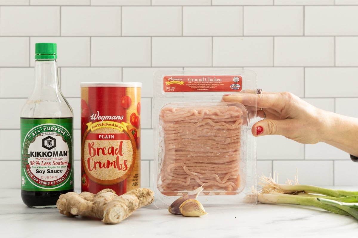 Ingredients for asian chicken meatballs on countertop.