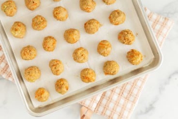 Asian chicken meatballs on baking sheet.
