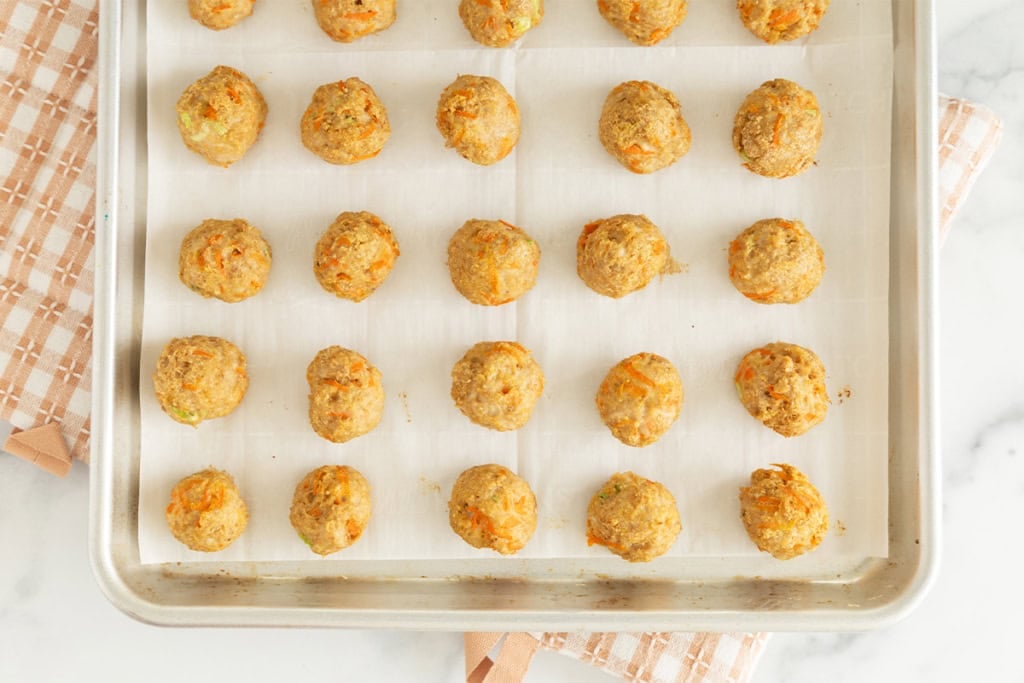 Asian chicken meatballs on baking sheet.