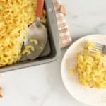 Baked mac and cheese on plate and in pan.