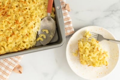 Baked mac and cheese on plate and in pan.
