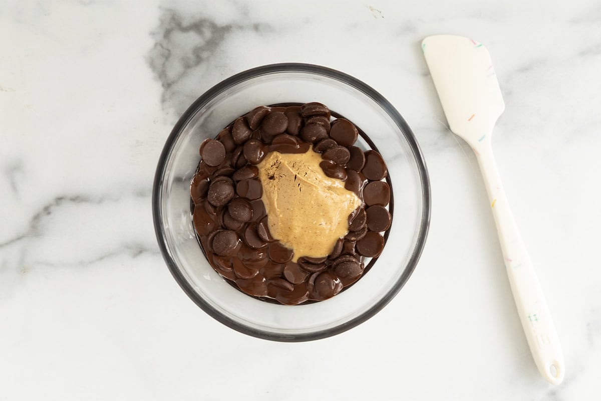 Chocolate and peanut butter in glass bowl for banana bites.