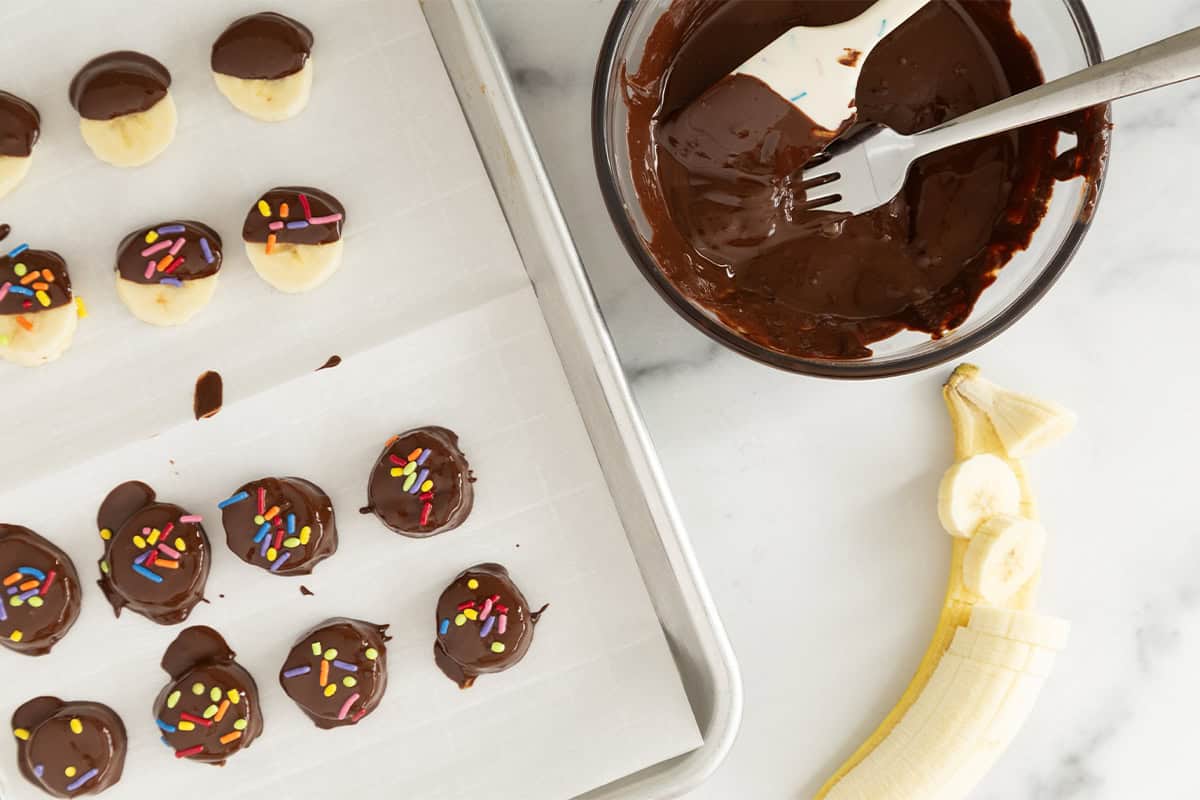 Making banana bites on parchment paper.