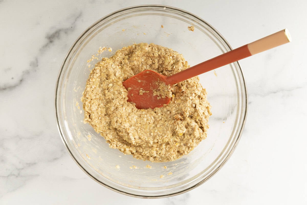 Batter for banana oatmeal cookies in glass bowl.