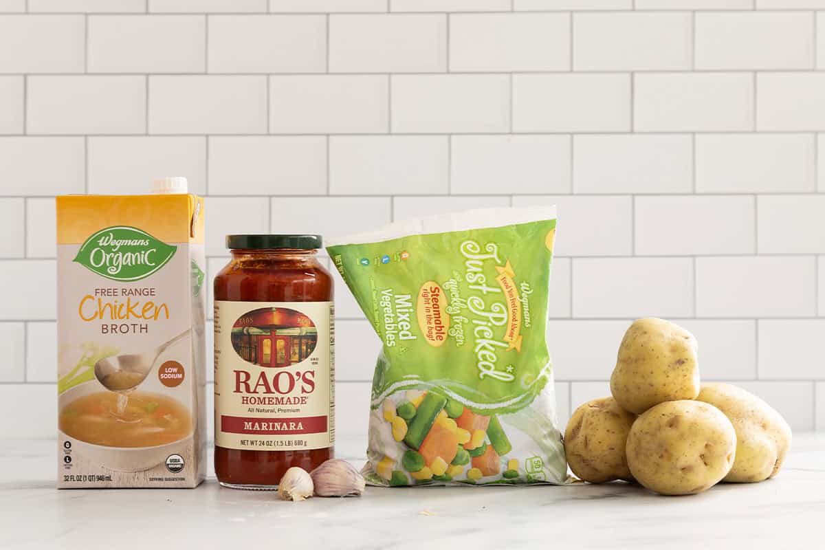 Ingredients for vegetable soup on countertop.