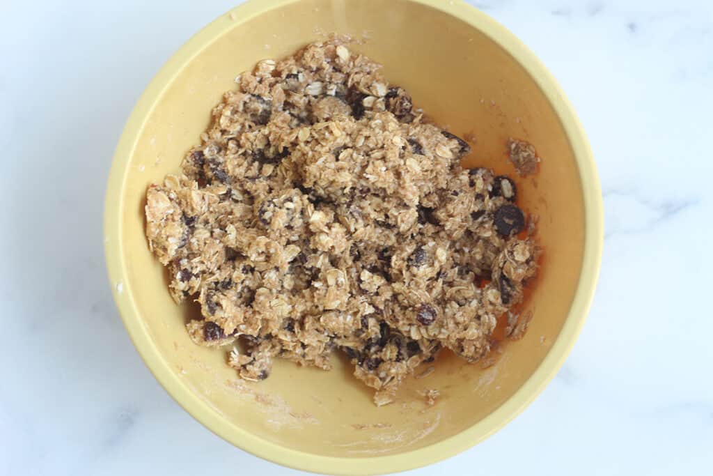batter for healthy oatmeal chocolate chip cookies in yellow bowl.