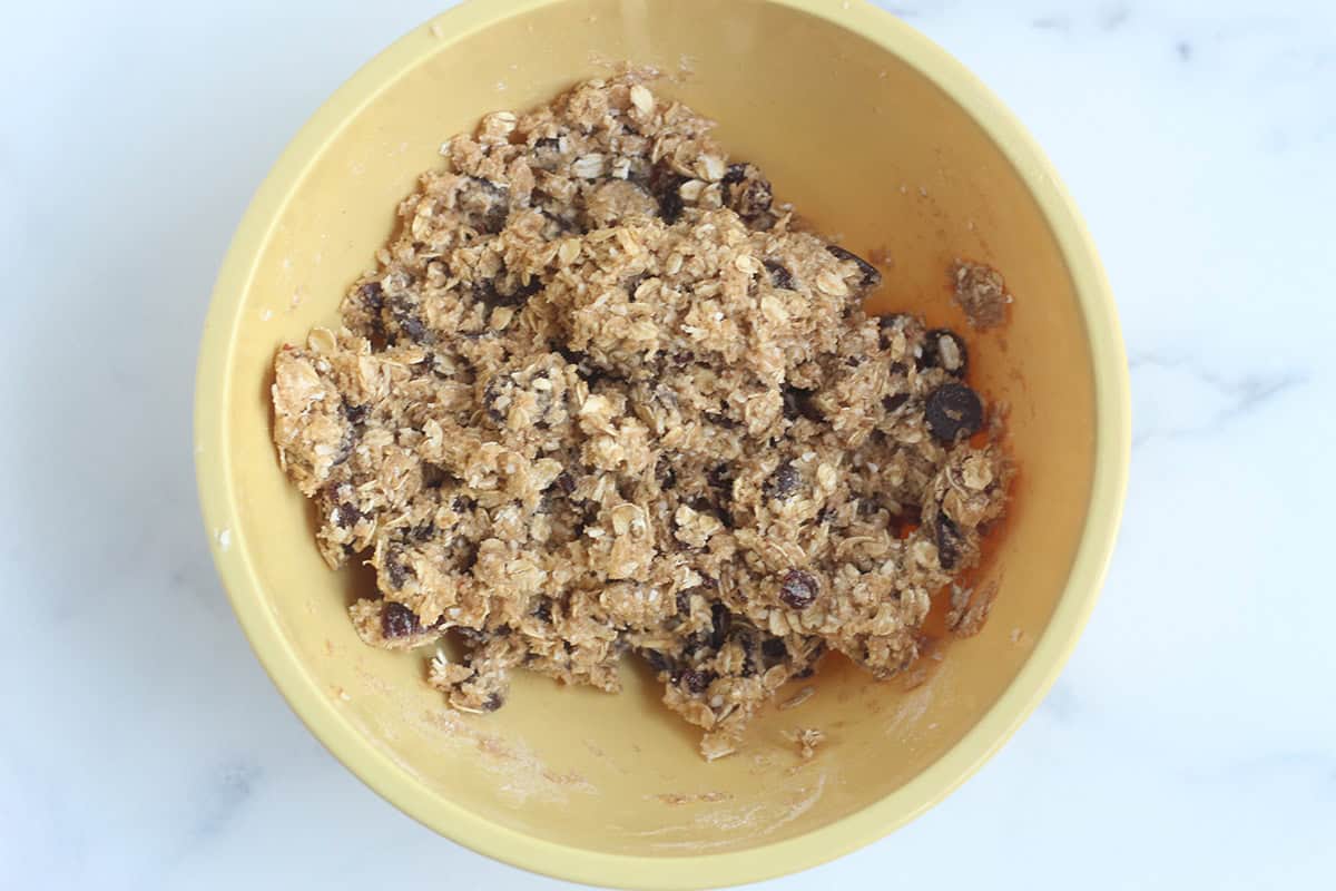 batter for healthy oatmeal chocolate chip cookies in yellow bowl.