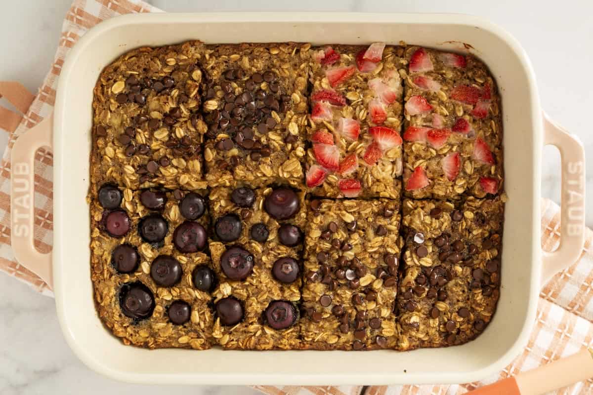 Baked oatmeal bars cut into rectangles in pan.