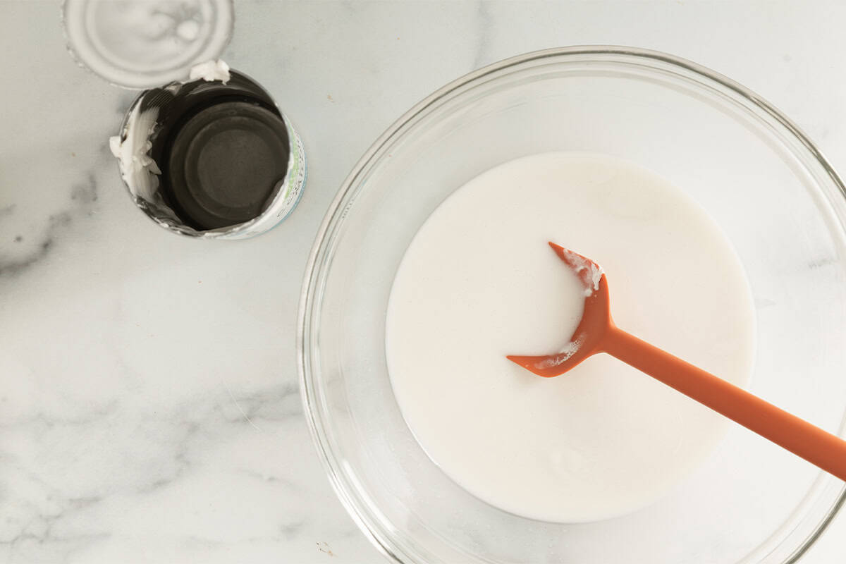 Coconut milk in glass bowl for coconut overnight oats.