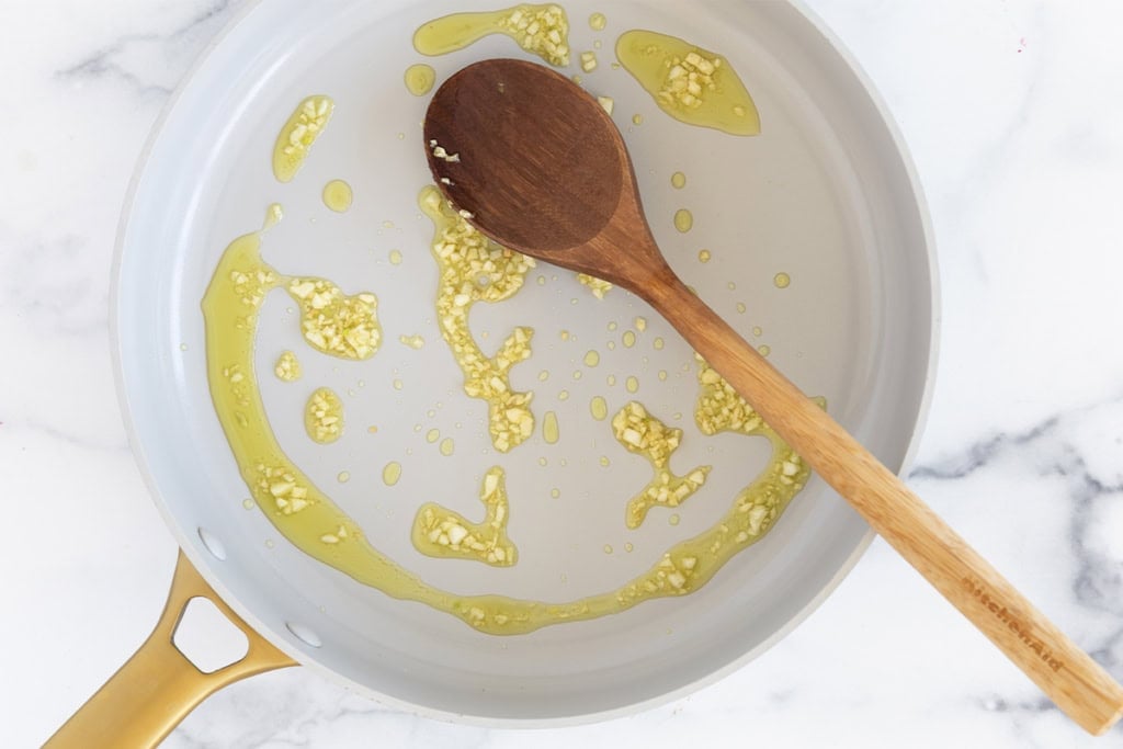 Garlic and olive oil in pan for yogurt sauce.