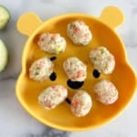 salmon rice balls on plate with avocado.