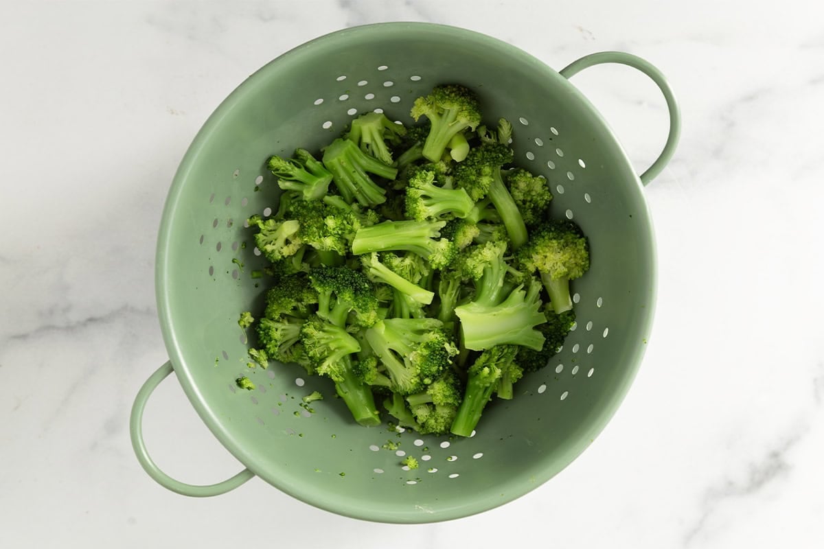Broccoli in strainer after cooking.