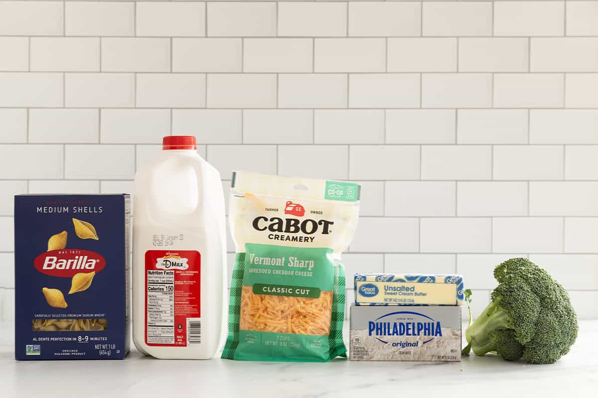 Ingredients for broccoli cheddar pasta on countertop.