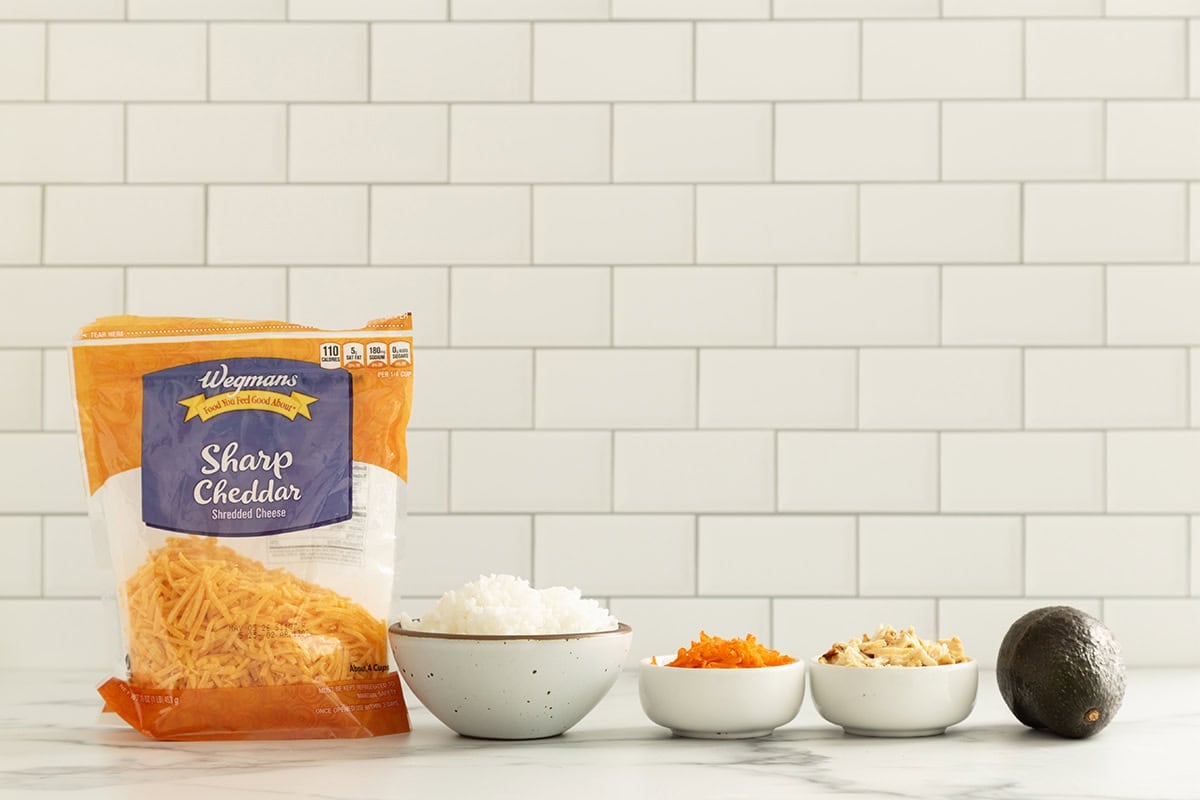 Ingredients for chicken and rice balls on countertop.