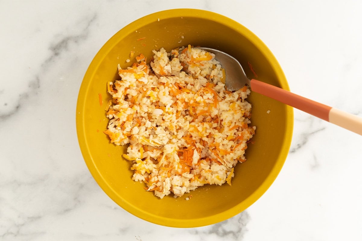 Mixture for chicken and rice balls in yellow bowl.